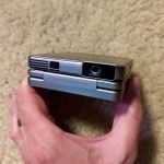 Aurzen ZIP Tri-Fold DLP Truly Mini Projector. Pocket Size. Zero-Lag Focus. One-Click Screen Mirroring. Full-Screen Mode. Type-C Fast Charging. 5.000mAh Battery. Indoor Outdoor Portable Projector.Gold